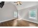 Well lit bedroom features hardwood floors, ceiling fan and windows overlooking a green space at 859 Heritage Lake Way, Grayson, GA 30017