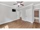 Bedroom with hardwood floors, doors, tv, and ceiling fan at 859 Heritage Lake Way, Grayson, GA 30017