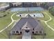 Aerial shot of a community clubhouse with a swimming pool and tennis courts for resident enjoyment at 859 Heritage Lake Way, Grayson, GA 30017