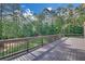 Expansive wooden deck featuring railings and views of the lush green lawn and mature trees at 859 Heritage Lake Way, Grayson, GA 30017