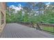 Large outdoor deck with gray wood and a view of the wooded backyard, perfect for entertaining and relaxation at 859 Heritage Lake Way, Grayson, GA 30017