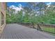 Large wooden deck with railing overlooks a lush backyard perfect for relaxation and outdoor gatherings at 859 Heritage Lake Way, Grayson, GA 30017