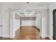 Dining room featuring hardwood floors, coffered ceiling, wainscoting and chandelier at 859 Heritage Lake Way, Grayson, GA 30017