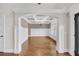 Dining room featuring coffered ceilings, wainscoting, hardwood flooring, and arched entryway at 859 Heritage Lake Way, Grayson, GA 30017
