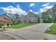 Spacious two-story home featuring a brick and stone exterior, attached garage, and long driveway at 859 Heritage Lake Way, Grayson, GA 30017