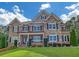 Beautiful two-story home featuring brick and stone facade, manicured lawn, and dark window shutters at 859 Heritage Lake Way, Grayson, GA 30017