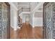 Grand foyer with hardwood floors, high ceilings, elegant staircase, and decorative glass entry doors at 859 Heritage Lake Way, Grayson, GA 30017