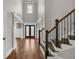 Stunning foyer with hardwood floors, staircase, and elegant front doors under soaring ceilings at 859 Heritage Lake Way, Grayson, GA 30017