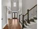 Elegant foyer featuring hardwood floors, high ceilings, and a staircase with iron balusters at 859 Heritage Lake Way, Grayson, GA 30017