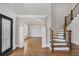 Elegant foyer with hardwood floors, staircase, decorative door and arched entrance to another room at 859 Heritage Lake Way, Grayson, GA 30017