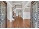 Grand foyer with high ceilings, hardwood floors, staircase, and decorative wrought iron front doors at 859 Heritage Lake Way, Grayson, GA 30017