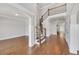 Bright foyer showcasing hardwood floors, staircase with iron spindles, and views of adjacent rooms at 859 Heritage Lake Way, Grayson, GA 30017