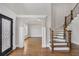 Inviting foyer features hardwood floors, elegant staircase with iron spindles and an ornate front door with decorative glass at 859 Heritage Lake Way, Grayson, GA 30017