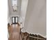 Grand foyer featuring a dark door, beautiful hardwood floors, and high ceilings with a statement chandelier at 859 Heritage Lake Way, Grayson, GA 30017