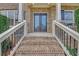 Inviting front porch with brick steps, wrought iron railings, and elegant double doors at 859 Heritage Lake Way, Grayson, GA 30017