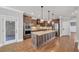 Bright kitchen features a large island with a sink, granite countertops, and stainless steel appliances at 859 Heritage Lake Way, Grayson, GA 30017