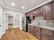 Kitchen view showcases granite countertops, stainless steel appliances, tile backsplash, and dark wood cabinets at 859 Heritage Lake Way, Grayson, GA 30017