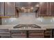 Modern kitchen with stainless steel range, tile backsplash, and custom cabinetry at 859 Heritage Lake Way, Grayson, GA 30017