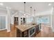 Open concept living room, kitchen and dining area features a large center island and stainless steel appliances at 859 Heritage Lake Way, Grayson, GA 30017