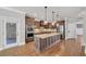 Kitchen with stainless steel appliances, a granite island, wooden floors and wooden cabinets at 859 Heritage Lake Way, Grayson, GA 30017