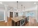 Kitchen with center island, stainless appliances, hardwood floors, and view into the living room at 859 Heritage Lake Way, Grayson, GA 30017