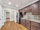 Kitchen area featuring rich wood cabinets, stainless steel appliances, granite countertops, and hardwood flooring at 859 Heritage Lake Way, Grayson, GA 30017