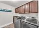 Spacious laundry room featuring a front loading washer and dryer with overhead cabinets at 859 Heritage Lake Way, Grayson, GA 30017