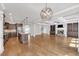 Open floor plan view of living room and kitchen with coffered ceilings, fireplace, and large center island at 859 Heritage Lake Way, Grayson, GA 30017
