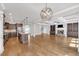 Large living room with a stone fireplace, coffered ceiling, hardwood floors and open to the kitchen at 859 Heritage Lake Way, Grayson, GA 30017