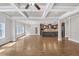 Living room with a coffered ceiling, hardwood floors, open layout with view into the kitchen at 859 Heritage Lake Way, Grayson, GA 30017