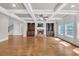 Living room featuring coffered ceiling, hardwood floors, fireplace and built-in bookcases at 859 Heritage Lake Way, Grayson, GA 30017