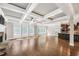 Spacious living room featuring coffered ceilings, hardwood floors, fireplace, and natural light at 859 Heritage Lake Way, Grayson, GA 30017