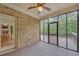 Screened porch with brick wall and view of the outdoors, and door to a living room with fireplace at 859 Heritage Lake Way, Grayson, GA 30017