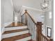 Staircase with wood steps, iron railings and a modern chandelier at 859 Heritage Lake Way, Grayson, GA 30017