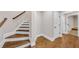 View of staircase with hardwood steps and white risers, leading to the upper level and hardwood floor at 859 Heritage Lake Way, Grayson, GA 30017