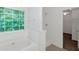Bright bathroom showcasing a garden tub, tiled shower and green leafy view at 11354 Conner Ct, Hampton, GA 30228
