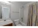 Compact bathroom featuring a shower-tub combo and neutral color palette at 11354 Conner Ct, Hampton, GA 30228