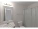 Neutral bathroom with a vanity, toilet, and a shower/tub combination with a curtain at 11354 Conner Ct, Hampton, GA 30228