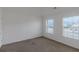 Bedroom with carpet floors, two windows with blinds, and white walls at 11354 Conner Ct, Hampton, GA 30228