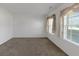 Well-lit bedroom with neutral walls and carpet, featuring large windows with sheer curtains at 11354 Conner Ct, Hampton, GA 30228