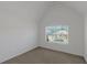Bright bedroom featuring neutral walls, plush carpeting, and a window offering outdoor views at 11354 Conner Ct, Hampton, GA 30228