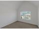 Bright bedroom with vaulted ceiling and large window showcasing the neighborhood at 11354 Conner Ct, Hampton, GA 30228