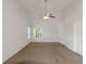 Spacious bedroom featuring neutral walls, plush carpeting, and a ceiling fan at 11354 Conner Ct, Hampton, GA 30228