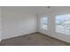 Unfurnished bedroom with a carpet, two windows offering natural light and a blank canvas at 11354 Conner Ct, Hampton, GA 30228