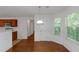 Light and airy dining area with hardwood floors and a window overlooking a green space at 11354 Conner Ct, Hampton, GA 30228