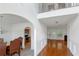 Bright foyer featuring hardwood floors and an arched entry leading to the dining area and living space at 11354 Conner Ct, Hampton, GA 30228