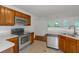 An eat-in kitchen with stainless steel appliances, light counters and wood cabinetry at 11354 Conner Ct, Hampton, GA 30228