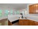 Bright kitchen featuring stainless steel sink, black appliances, and natural light from the windows at 11354 Conner Ct, Hampton, GA 30228