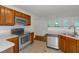 Bright kitchen featuring stainless steel appliances, wood cabinets, and a view into an adjacent room at 11354 Conner Ct, Hampton, GA 30228