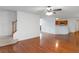 Open concept living area with hardwood flooring, staircase, and access to the kitchen at 11354 Conner Ct, Hampton, GA 30228
